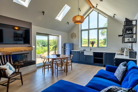 Gather, cook, and unwind in the living space with sweeping pastoral views