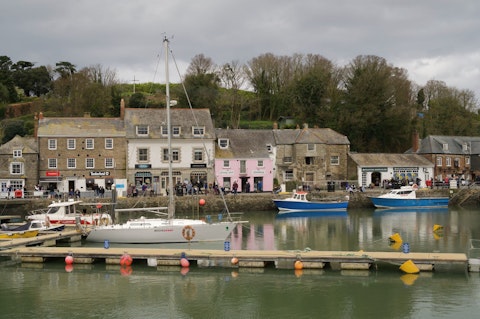 Explore Padstow Harbour's charming quayside and seafood restaurants, a sixteen-minute drive