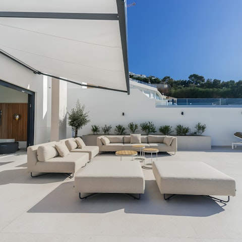 Sip sundowners and watch the sunset on the outdoor sofas