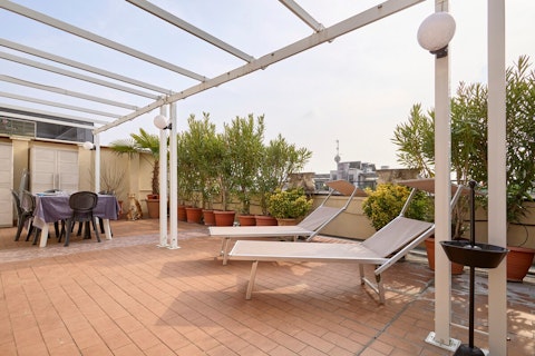 Stretch out on sun loungers above the Milan skyline