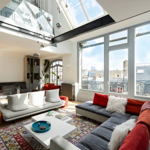 Admire views of Paris' rooftops from the glass-fronted sitting room