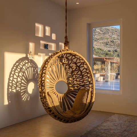 Hang about in the wicker egg chair whilst looking out at the Aegean Sea