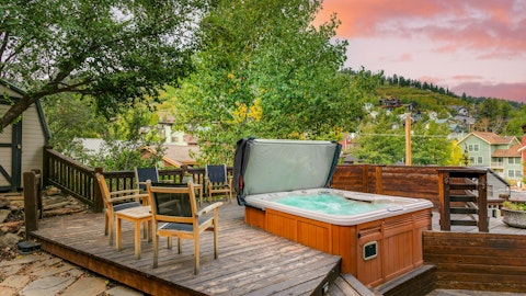 Soak in the hot tub as a pink sky settles over the hills