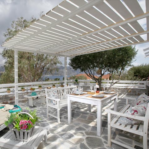 Share hummus and flatbreads under the white pergola