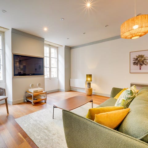 Settle down in the colourful living space for a cosy movie night in