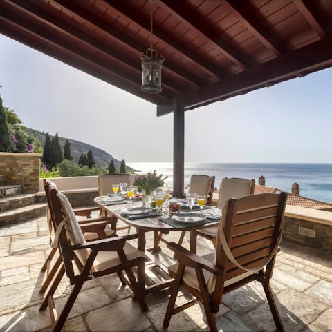 Watch the sun set into the Aegean Sea as you dig into supper