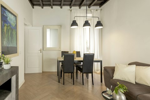 Dine under soaring original ceilings in this light-filled Roman apartment