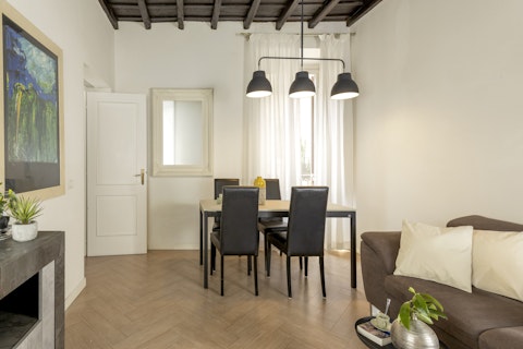 Dine under soaring original ceilings in this light-filled Roman apartment