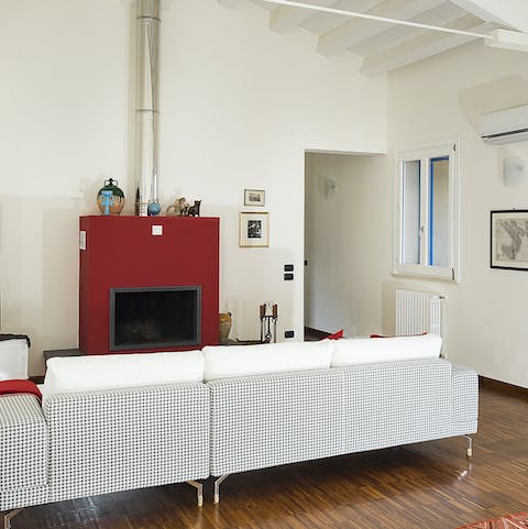 Gather round the modern fireplace on a rare chilly evening