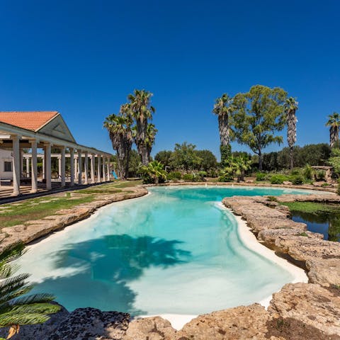 Take a dip in this rock-carved swimming pool, right by a pond scented with water lilies