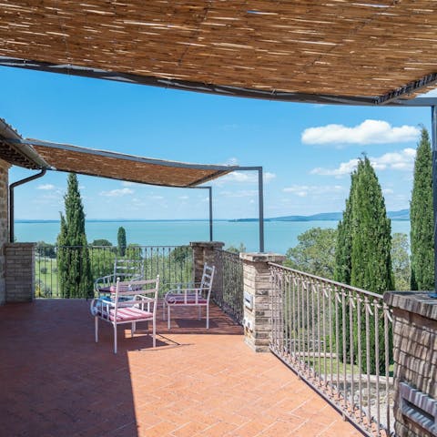 Sip wine on the terrace as you drink in the lake views