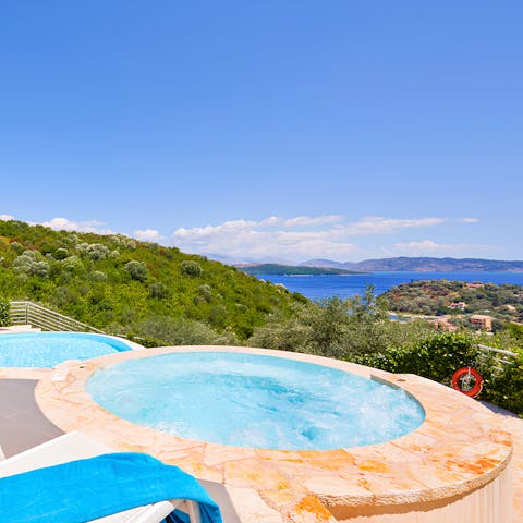 Relax in the hot tub as you drink in the sea views