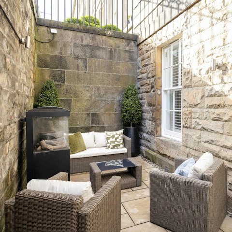 Relax with a wee dram next to the outdoor fireplace when the Scottish weather turns chilly