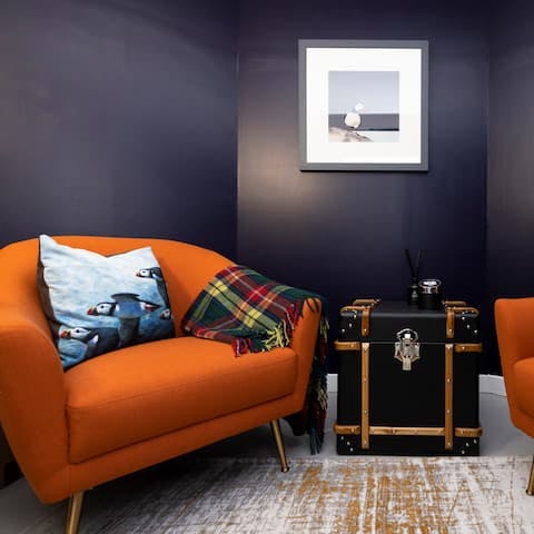 Read one of the art books on the comfy terracotta hued armchair in the secret outdoor room