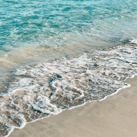 Get some peace and quiet at the sand-and-pebble shores of Es Torrent Beach