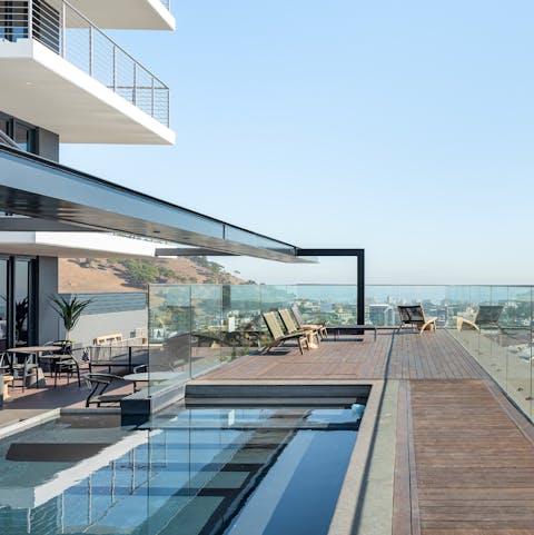 Take a dip in the communal rooftop pool with panoramic views all around