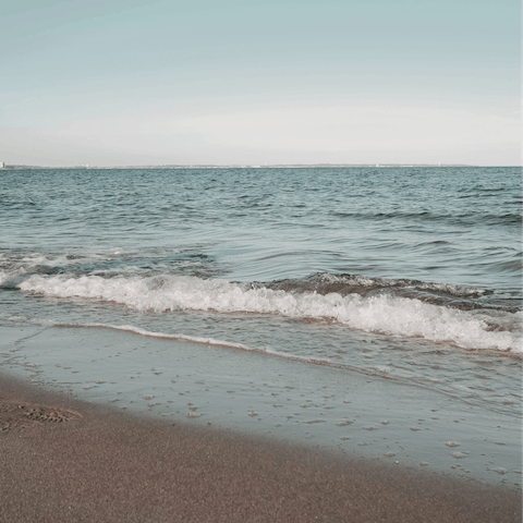 Soak up the sun on Agios Stefanos beach, a five-minute drive away