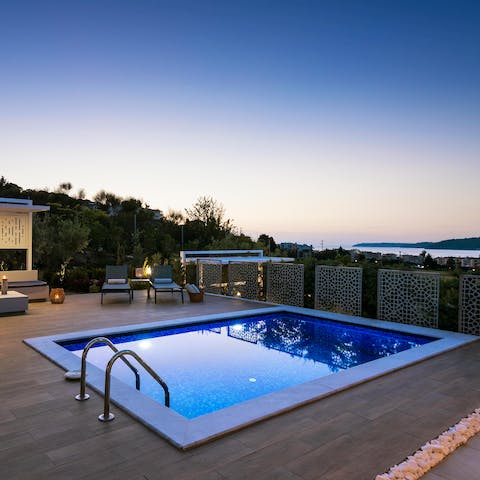 Take an evening swim as the sun begins to set across the Aegean Sea