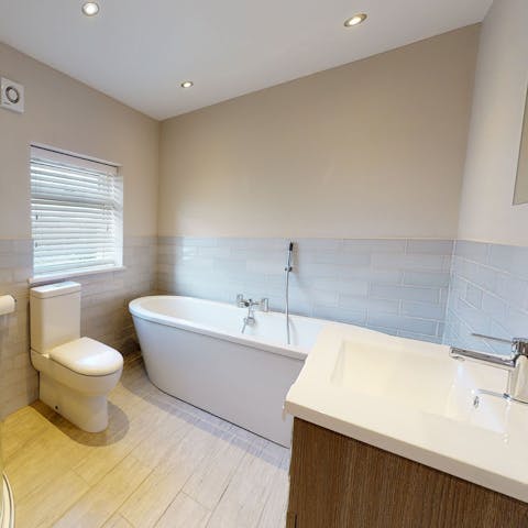 Soak in the free-standing bathtub, after a day on Abersoch Beach