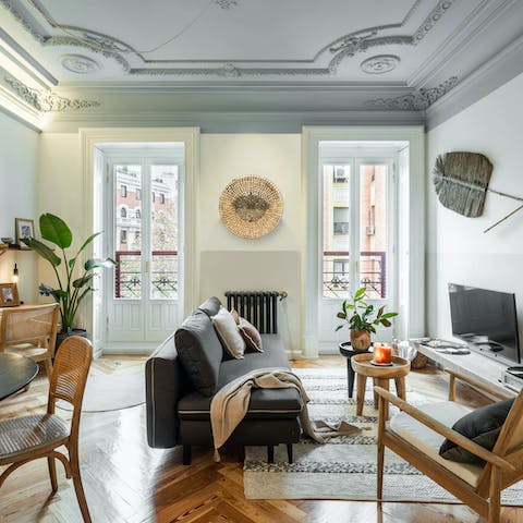 Kick back and relax in the elegant living room as sunlight pours in through the French doors