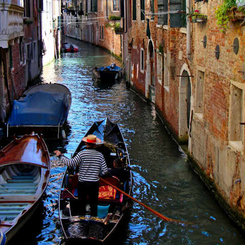 Hop on a gondala to explore the canals of Venice