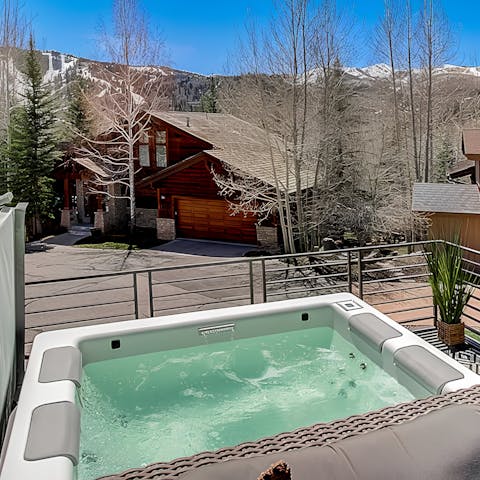 Soak in the private hot tub with mountain views.