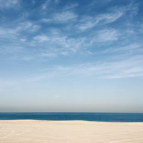 Sink your toes into the soft sand of Marina Beach