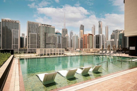Put your feet up by the communal pool as you soak up the Dubai sun