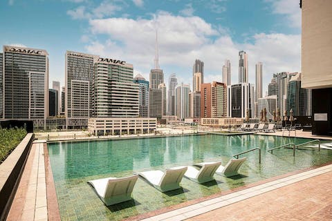 Put your feet up by the communal pool as you soak up the Dubai sun