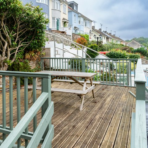 Unwind and socialize at the picnic bench on the front patio of the home