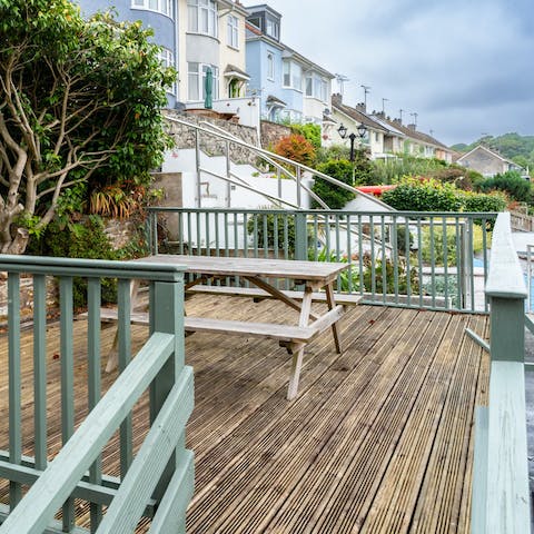 Unwind and socialize at the picnic bench on the front patio of the home
