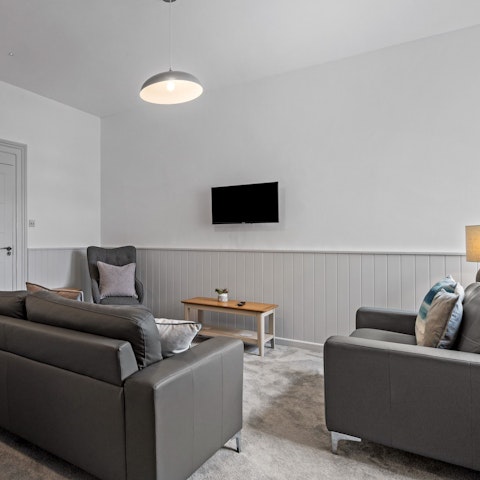 Kick back and relax on lounge-worthy leather sofas in the light-filled living room