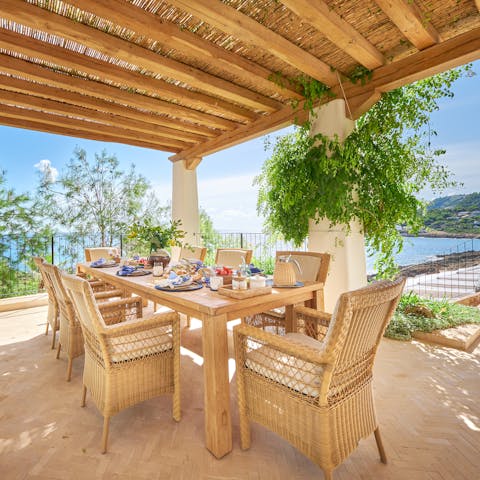 Dine on the terrace while taking in the sea views