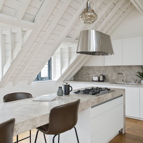 Knock up a lazy brunch in the contemporary marble-topped kitchen