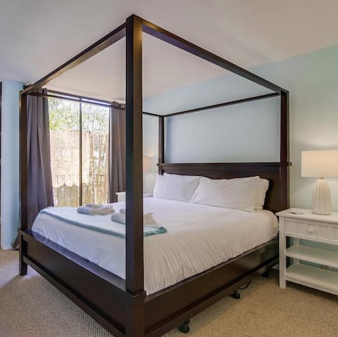 Dream on the sleek four-poster bed