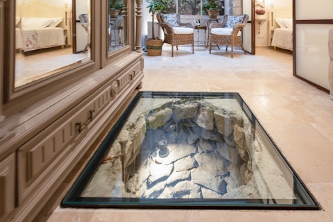 Walk over ancient ruins preserved beneath the floor