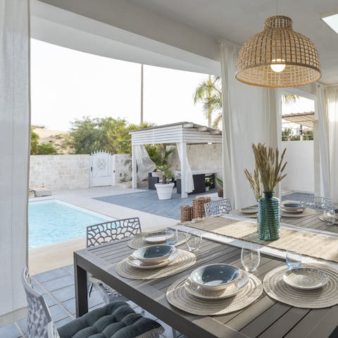 Dine alfresco style before relocating to the poolside chill-out spot with a cocktail in hand