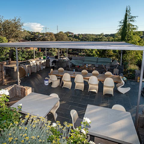Fire up the barbecue and gather for alfresco lunches beneath the pergola