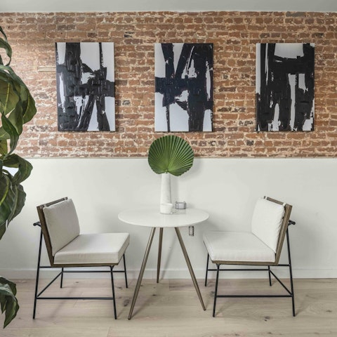 Nibble on bagels in front of the exposed brick