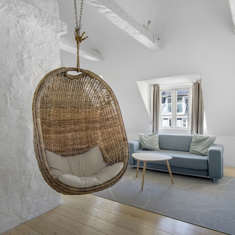 Swing on the egg chair in the breezy living space