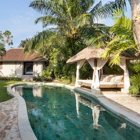 Relax on the day bed by the private pool