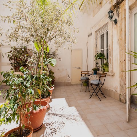 Relax on the leafy terrace with a glass of Prosecco