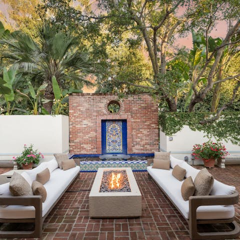 Gather around the firepit for cocktails as the sun sets