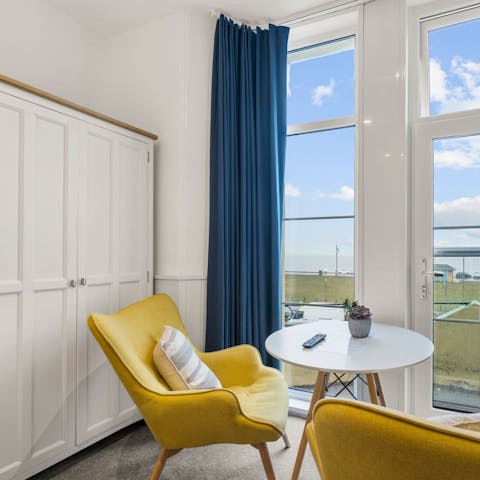 Begin the morning with breakfast and coffee around the small table, gazing at the sea views