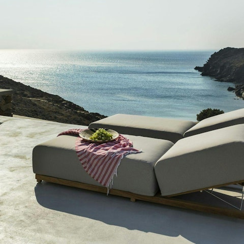 Lounge by the pool and admire the sea views