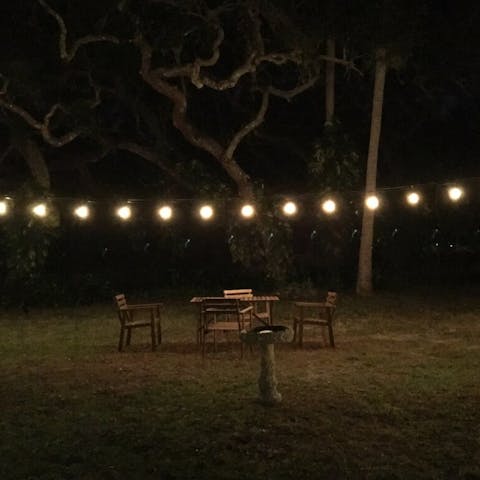 Sit under the string lights in the garden  for magical evenings together