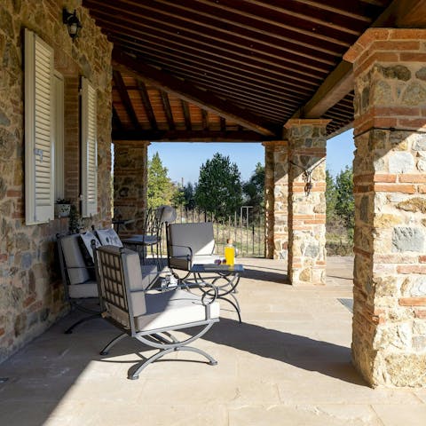 Relax on the covered terrace with your morning coffee