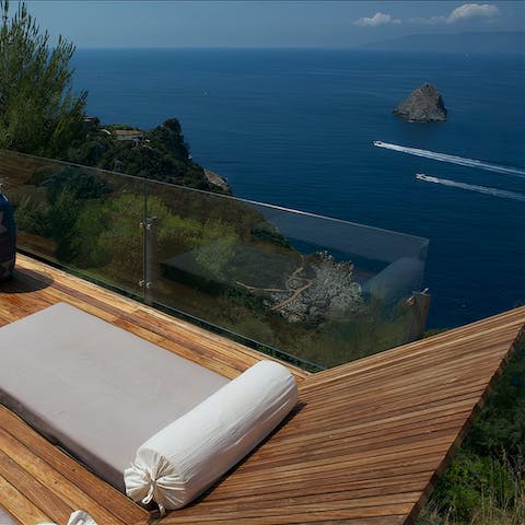 Relax on the sun loungers while you watch the boats pass by