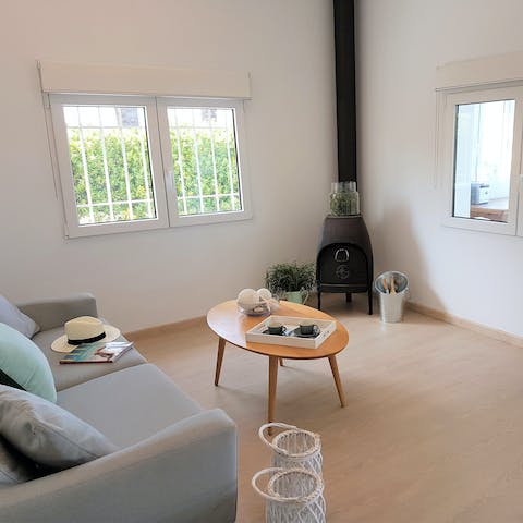 Cosy up on the sofa by the wood burning stove at chillier times of year