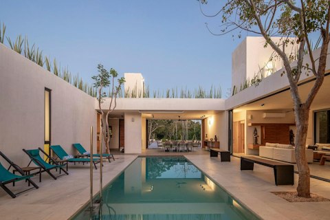 Swim as dusk settles over the open-air courtyard